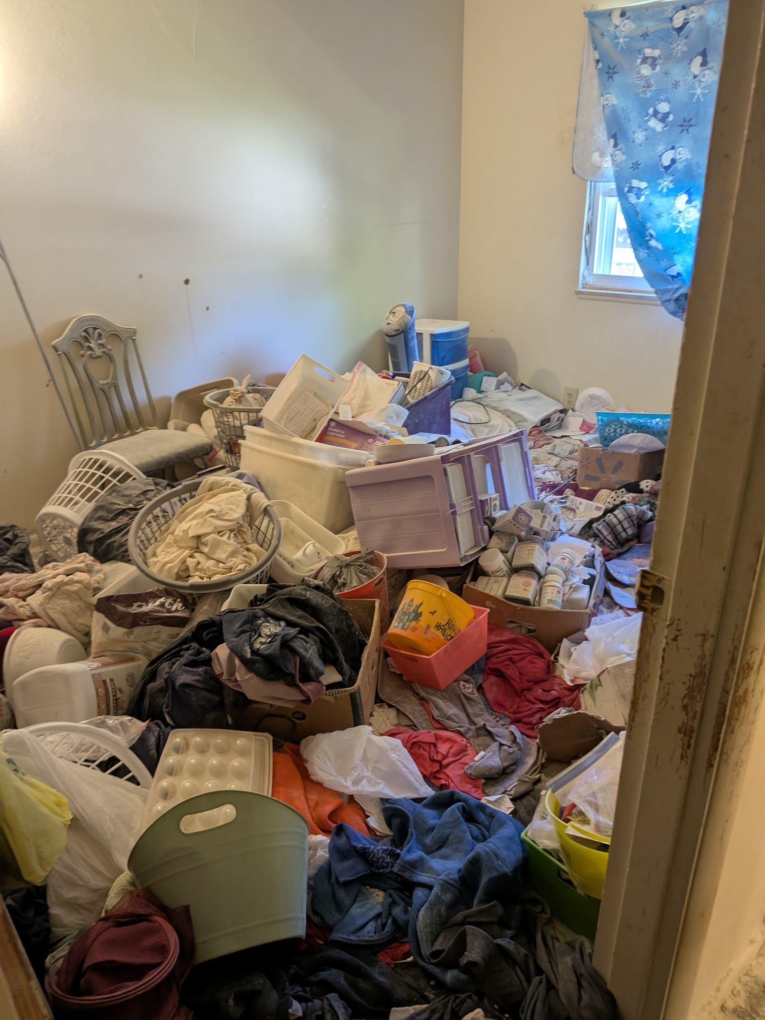 Heavily cluttered room before cleanout
